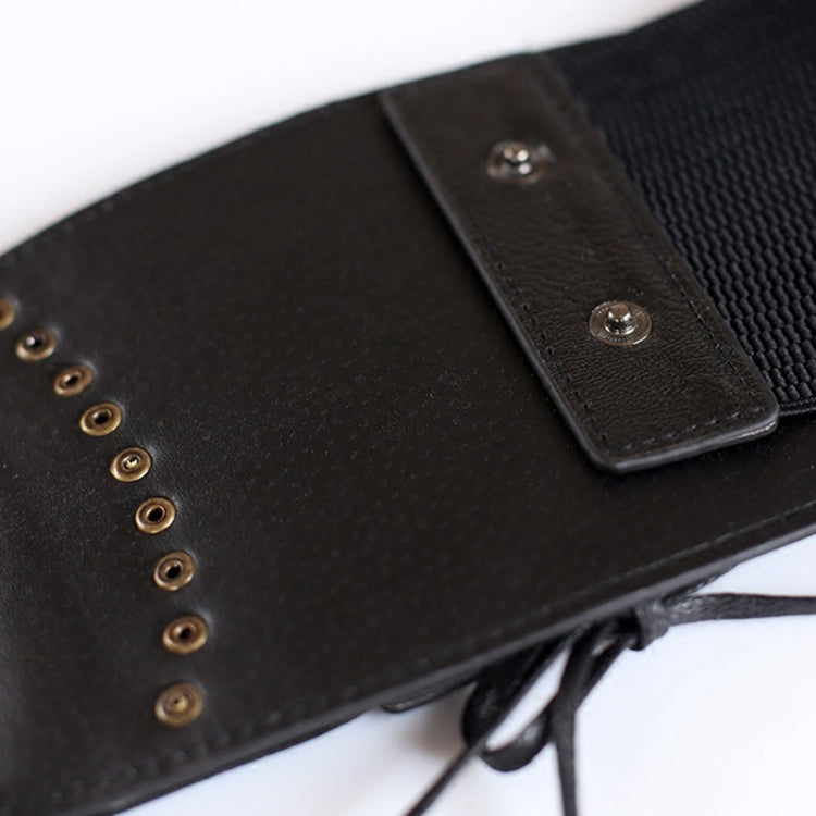 Black wide belt strap with metal eyelets and tied tassel cords