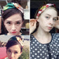 Women’s cross headband with green base and floral print on top