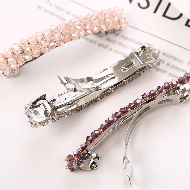 Sparkly elastic hair clips with rhinestones in pink, clear, and dark red tones