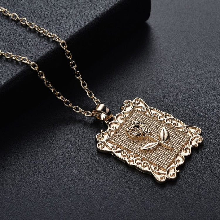 Gold geometric square rose pendant necklace with ornate filigree, angled close-up