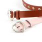 Close-up of brown and light pink narrow leather belts with silver heart buckles