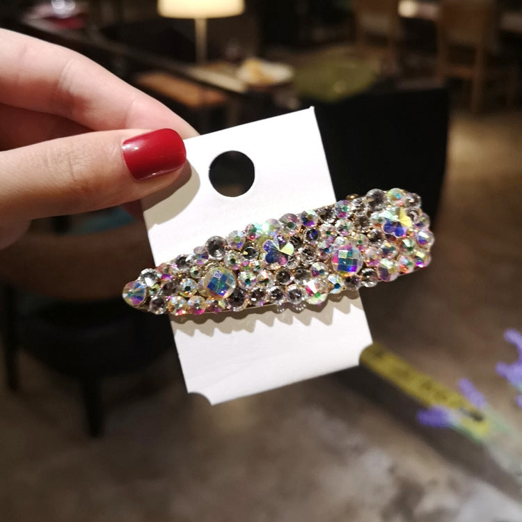 Sparkling rhinestone hair barrette with multicolor crystal shine and faux pearl details