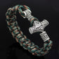 Braided rope bracelet with curved silver-tone Thor hammer charm near knot, teal mix