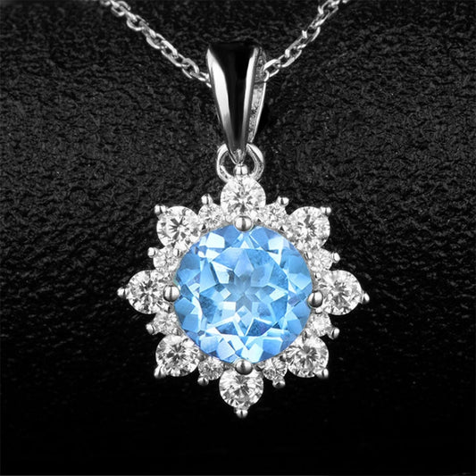 Close-up of blue gemstone snowflake pendant necklace with clear stone accents
