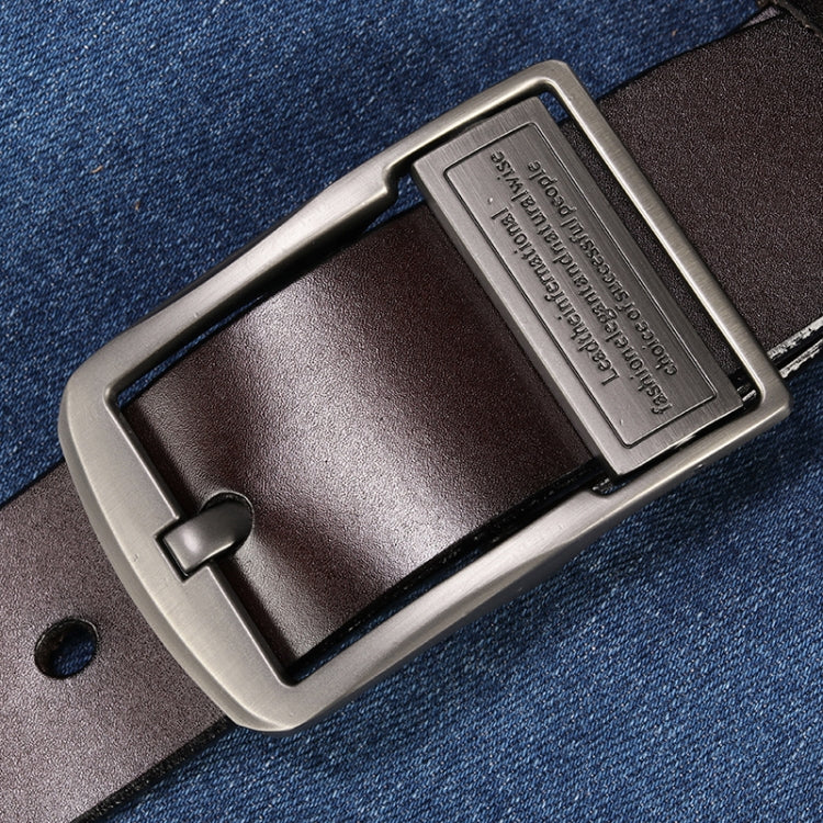 Leather pin buckle belt on denim, with brushed metal buckle