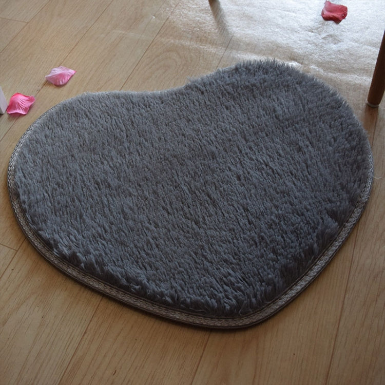 Dark gray heart-shaped bath mat with dense shag texture and non-slip backing.