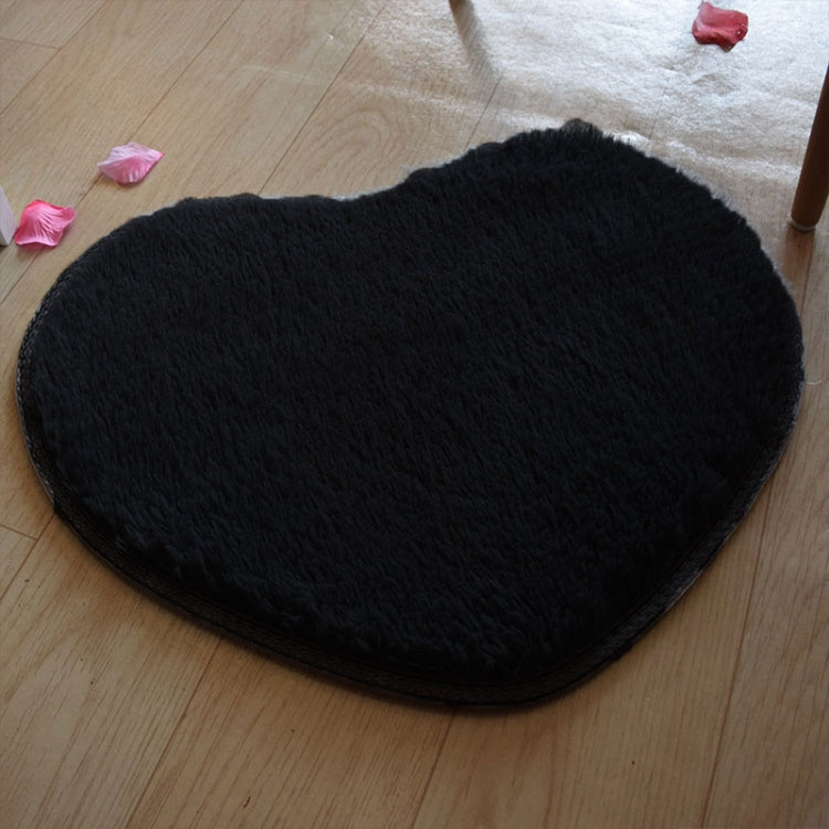 Black heart-shaped bath mat with plush shag texture and non-slip edge binding.