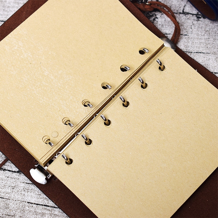 Spiral notebook journal with kraft paper pages and metal rings, on brown leather cover