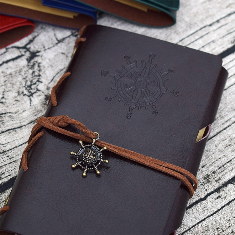Dark blue pirate spiral notebook journal with embossed compass design and brown leather strap
