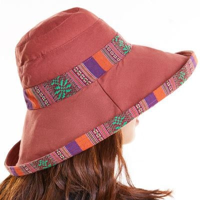 Rust red wide-brim beach hat with multicolor woven band