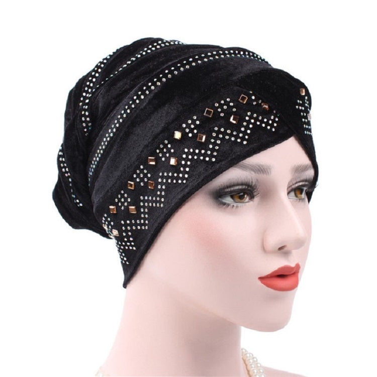 Black pleuche turban hat with rhinestone trim and decorative square accents