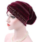 Red wine pleuche turban hat with rhinestone trim and dotted square pattern, side view
