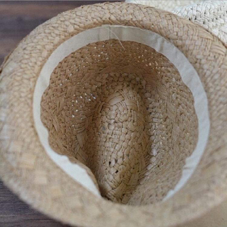 Children's khaki straw panama hat top view with round crown and dark striped band