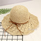 Beige wide-brim straw sun hat with knotted ribbon ties around the crown