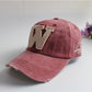 Wine red canvas baseball cap with light beige 'W' applique and red side badge