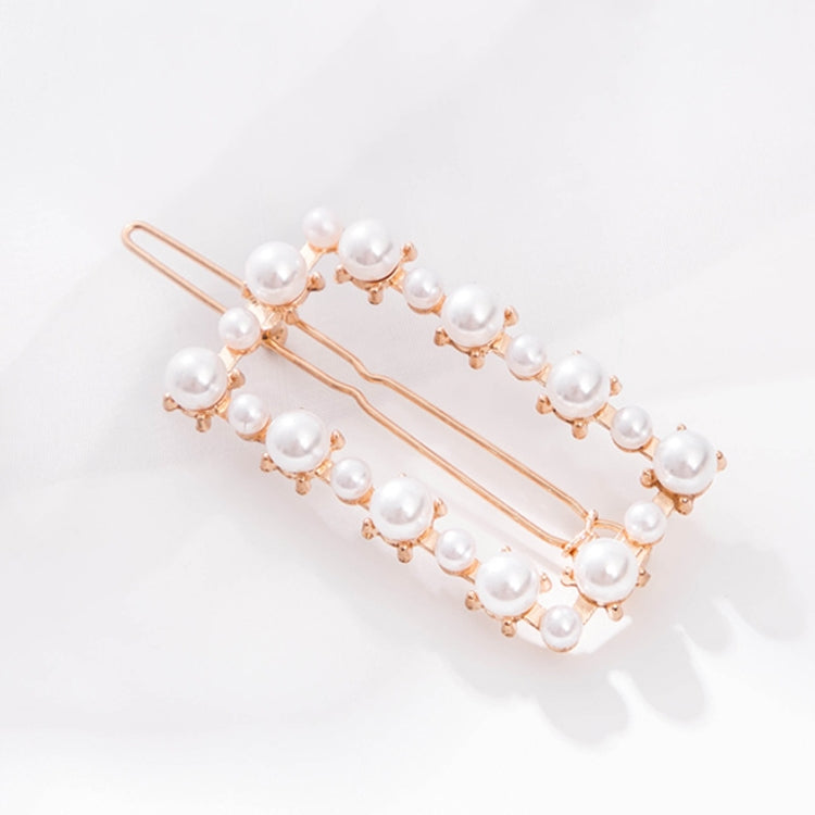 Rose-gold pearl hairpins with white beads along two hair clips
