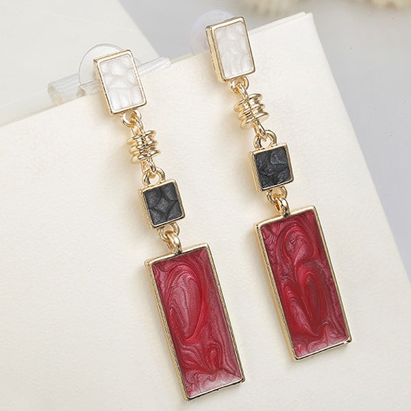 Pair of gold-tone geometric earrings with red rectangle marbled drops and black center squares