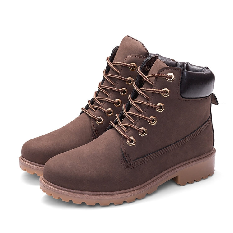 Brown lace-up Martin boots with thick tread sole and metal eyelet lacing