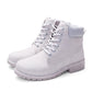 Pair of white lace-up warm ankle boots with padded collar and rugged tread sole