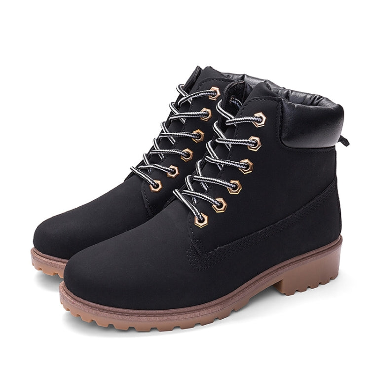 Black winter boots, lace-up with padded collar and side tab, rugged brown lug outsole