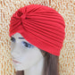 Red draped turban head wrap with gathered stripes and front knot