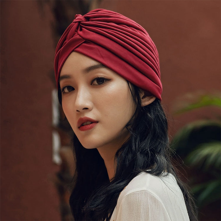 Wine red turban head wrap on woman, side view with twisted front knot