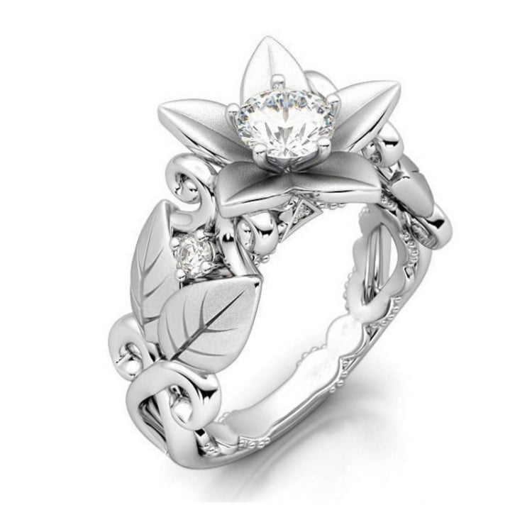 Silver flower wedding ring with central clear stone and diamond accents