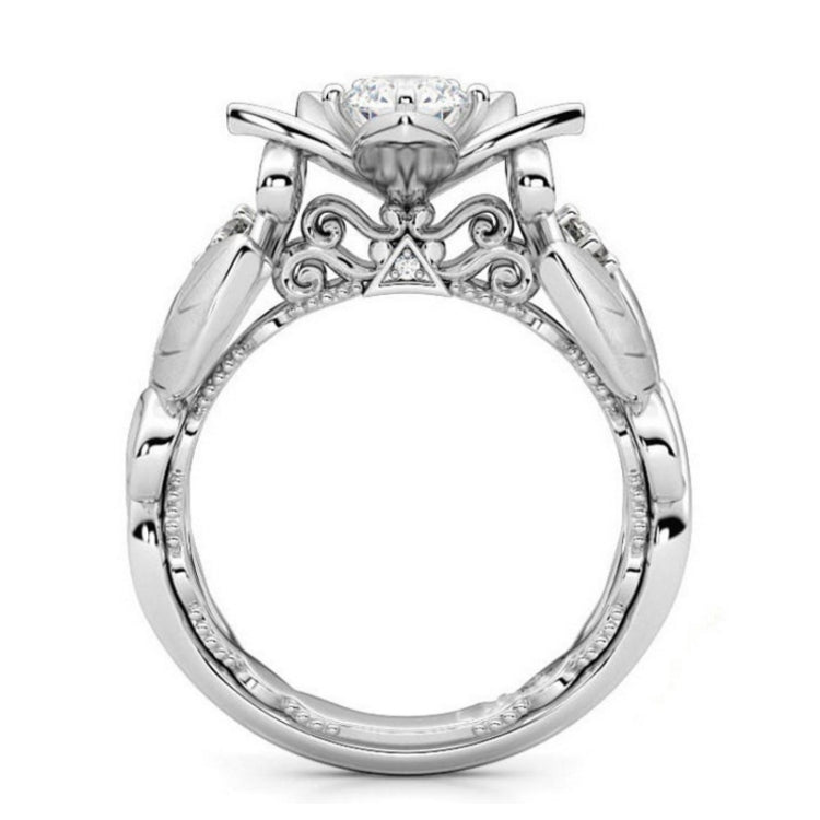 Silver ring front view with filigree details and central round stone