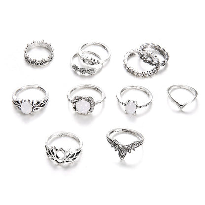 Silver-tone ring set with opal-style stones and filigree detailing, 11-piece assortment