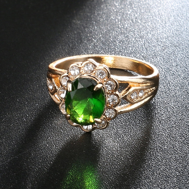 Gold oval green center gemstone ring with round clear stone halo and side clusters