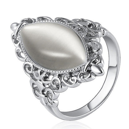 Silver oval cabochon ring with vintage filigree band and ornate round side links