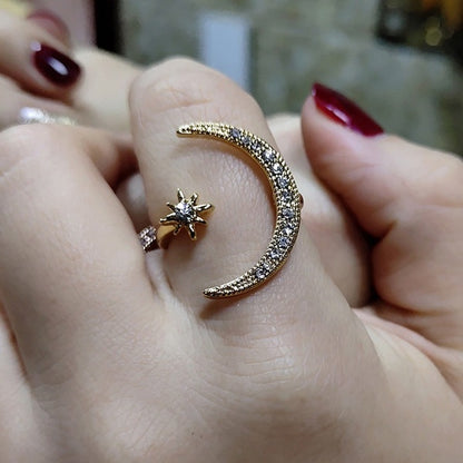 Silver-tone crescent moon crystal ring with star accent and sparkle band on finger