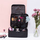 Black large cosmetic bag open with brush organizers and mesh top pocket, zip closure.