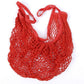 Red mesh tote bag with long handles and open woven net design