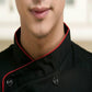 Close-up of black chef jacket collar with red piping and snap/button detail