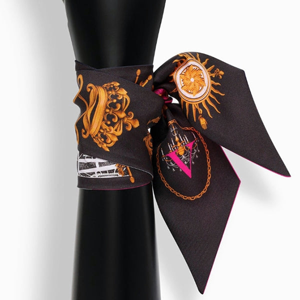 Tarot letter small scarf with ornate sun and chain motifs on dark fabric, tied around neck