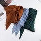 Pleated silk square scarves in brown, light blue, and dark green, tied with striped ends