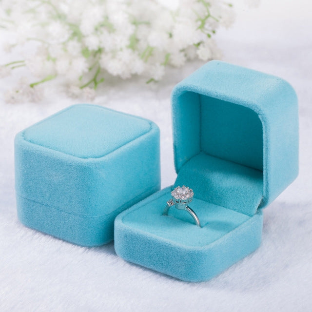 Sky blue velvet ring jewelry box set, one closed and one open with ring