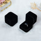 Black velvet ring jewelry box set, one closed and one open with silver-toned ring