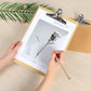 Wooden clipboard with metal clip holding printed photo page