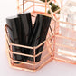 Rose gold hexagonal pen cup holder with black brush containers in open wire frame