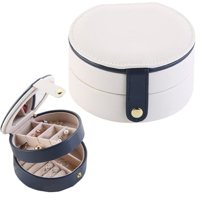 Two-tier jewelry storage box with round lid, navy strap and hinged open compartment.