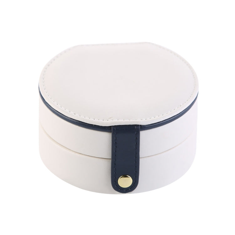 Two-tier jewelry storage box with round white lid and navy strap closure.