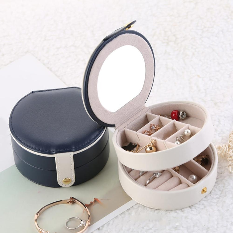 Open two-tier jewelry storage box with navy lid and beige compartments