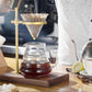 Brass hand coffee filter holder with glass carafe and paper filter cone