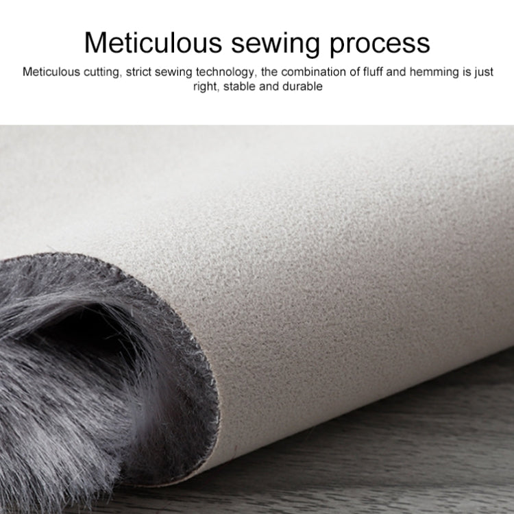 Dark gray faux wool cushion mat with rolled fur edge and backing