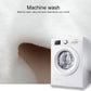 White faux wool cushion mat beside a front-load washing machine