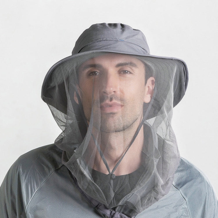 Person wearing wide-brim mosquito net sun hat with mesh face cover and chin cord, gray
