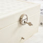 Close-up of white jewelry storage box lock and metal handle hardware