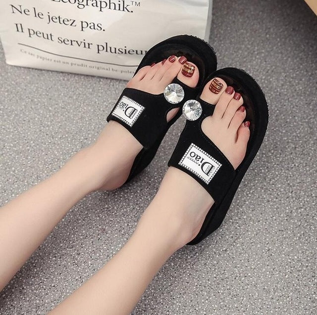 Black rhinestone slide sandals with crystal toe details and wide strap, platform sole
